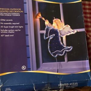 A pair (2) Vintage Lighted Angels with trumpet. Has wire and plug in.